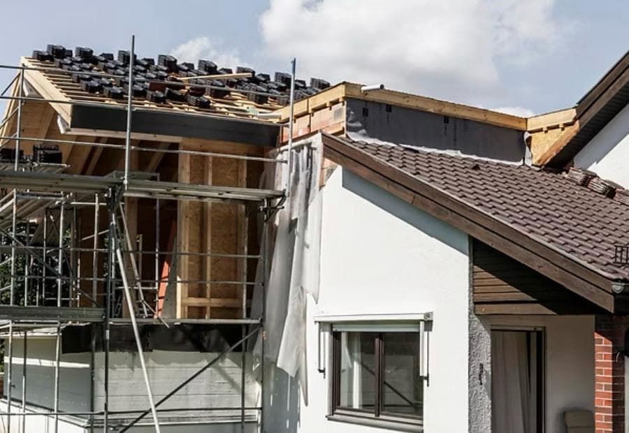 New roof under construction with fresh battens and breather membrane